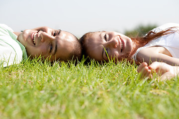 Image showing Young couple relaxing on a lawn