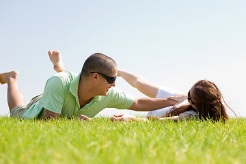 Image showing Young man playing with his wife on a grass