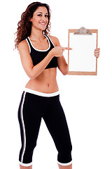 Image showing Fitness woman showing a blank clip board