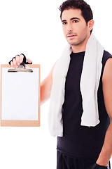 Image showing Fitness Man showing a blank clip board