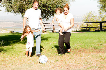 Image showing Parents and kids playing football