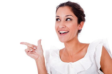 Image showing Close up portrait of a happy young woman pointing up at copyspace