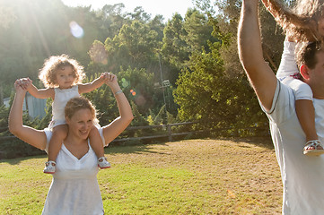 Image showing Parents giving a shoulder ride to kids