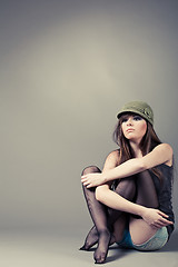 Image showing Beautiful young girl sitting with her knees pulled up