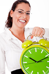 Image showing Young happy woman carrying a old clock