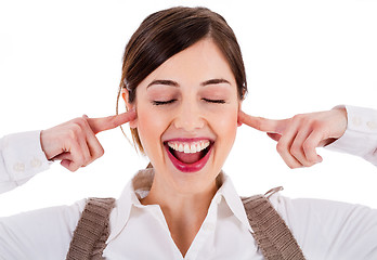 Image showing smiling young attractive model closing her eyes and ears