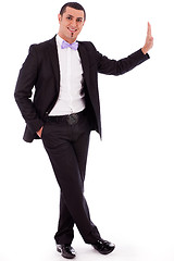 Image showing Full body of a business man standing against the wall