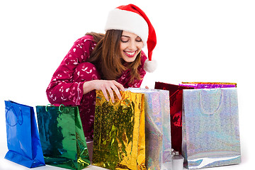 Image showing Santa girl looking into the shopping bags