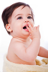 Image showing Baby with finger in mouth looking up