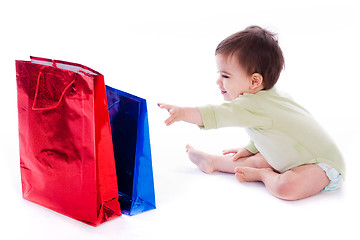 Image showing Baby trying to pull the shopping bag