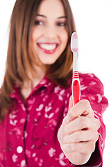 Image showing Young women showing the toothbrush