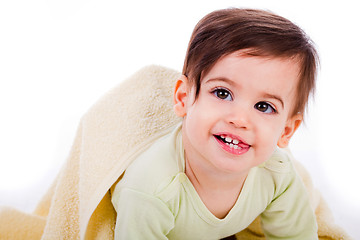 Image showing Infant crawling with towel and smiling