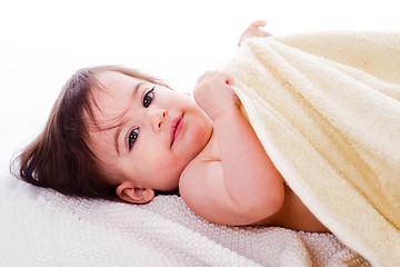 Image showing Little baby lying in white towel and wrapped with yellow towel