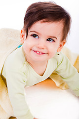 Image showing Cute baby smile under yellow blanket