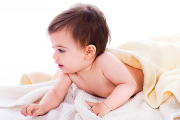 Image showing Infant lying under the yellow towel