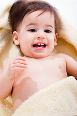 Image showing Portrait of a happy baby wrapped in yellow towel