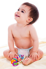 Image showing Baby sitting with toys and smile