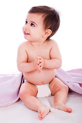 Image showing Baby sitting with a purple towel