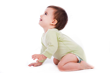 Image showing Side pose of baby sitting and looking up