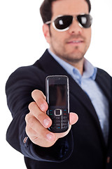 Image showing Business man wearing sunglasses and showing a Nokia mobile