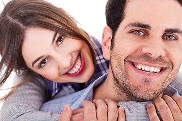 Image showing Cute girl holding her hands round the neck of her boyfriend and smiling