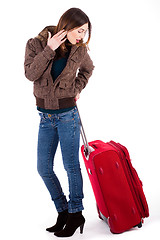 Image showing Women ready for travel and looking her luggage