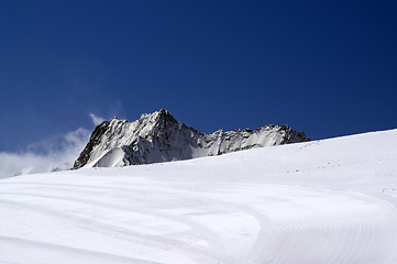 Image showing Ski slope against mountain peaks