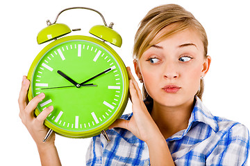 Image showing Girl giving funny expression and holding the alarm