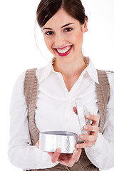 Image showing Women smiling and happily opening her gift