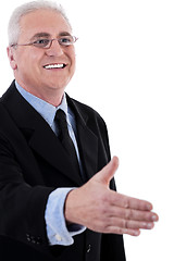 Image showing Senior business man holding out his hand for a handshake