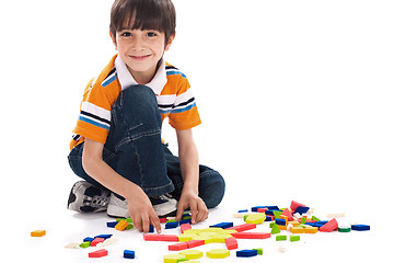 Image showing Adorable caucasian boy joining the blocks while playing