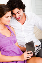 Image showing happy young couple looking at cds