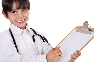 Image showing Little boy doctor writes on his clipboard for diagnosis