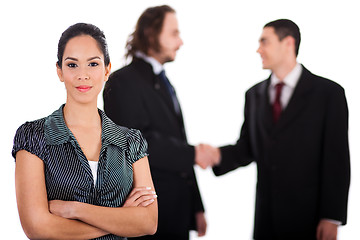 Image showing Smiling business women in focus with two business collegue welcoming each other