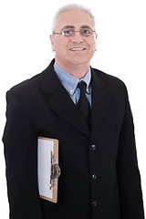 Image showing Mature business man holding a clipboard