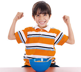 Image showing Young boy shows his strength by raising his arms