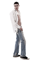 Image showing A muscular model in a white open shirt and jean