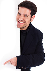 Image showing Portrait of a business man pointing at the blank board