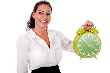 Image showing Young business woman showing a green colour clock