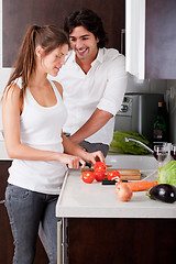 Image showing woman sliceing tomatoes with her boyfriend