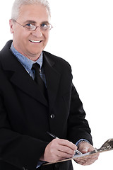 Image showing Portrait of smiling business man writing on pad