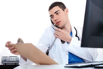 Image showing Doctor convey his notes to others over phone