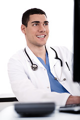 Image showing Smiling young doctor at his office