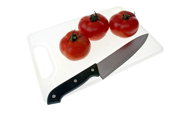 Image showing Cutting board with a knife and tomato