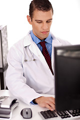 Image showing young physician working on his office