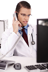 Image showing Male physician talking over phone