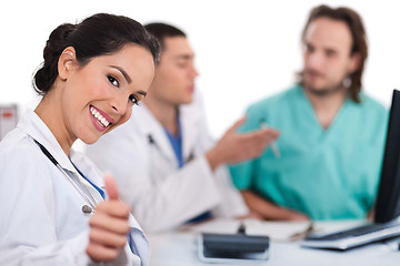 Image showing Asian women doctor show ok sign, two other team mates talking deeply