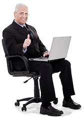 Image showing Mature business man shows thumbs up on successful business