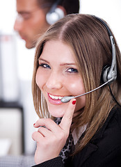 Image showing Business woman speaking through head phone