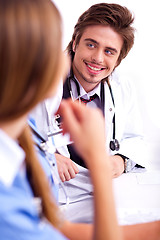 Image showing Smiling male doctor looking the side cornor